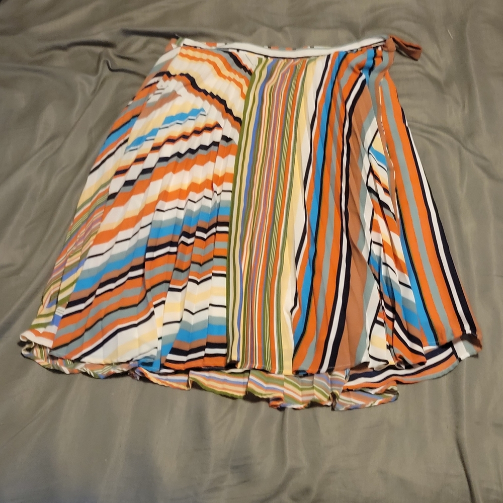Multi color stripped knee length skirt with buttons on the inside and a string.